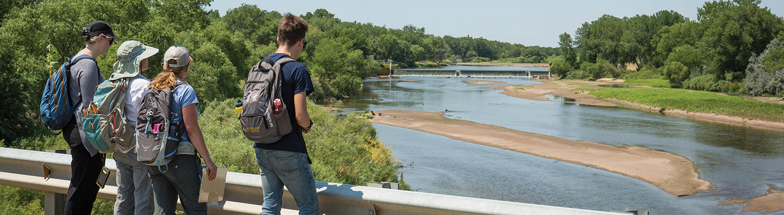 Group of geographic information systems students gathered near edge of road